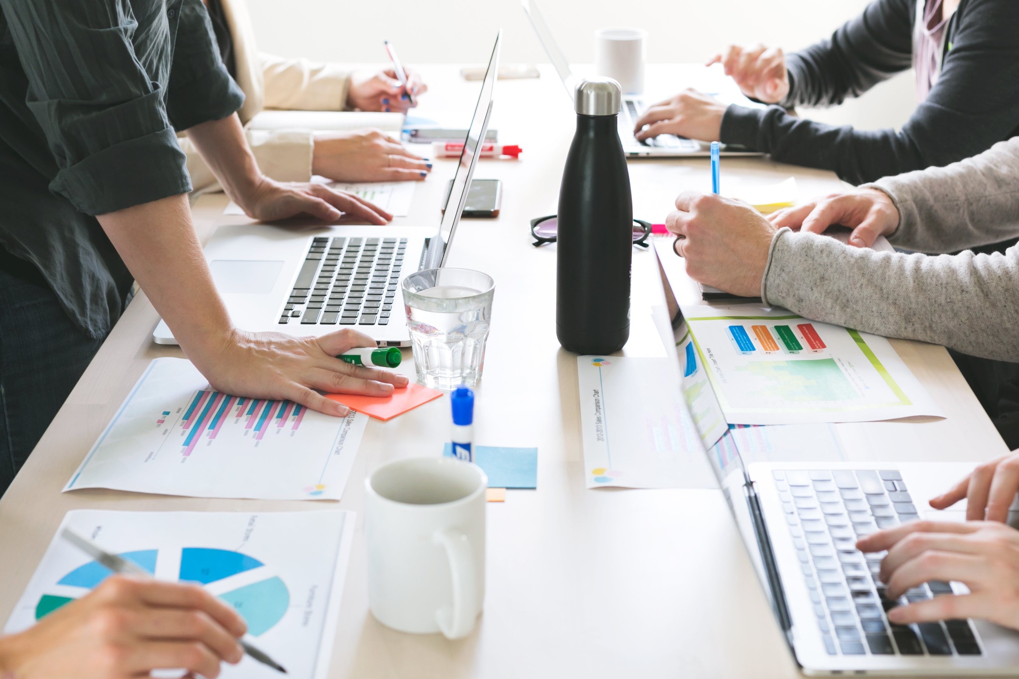 Professionals collaborating around a project table